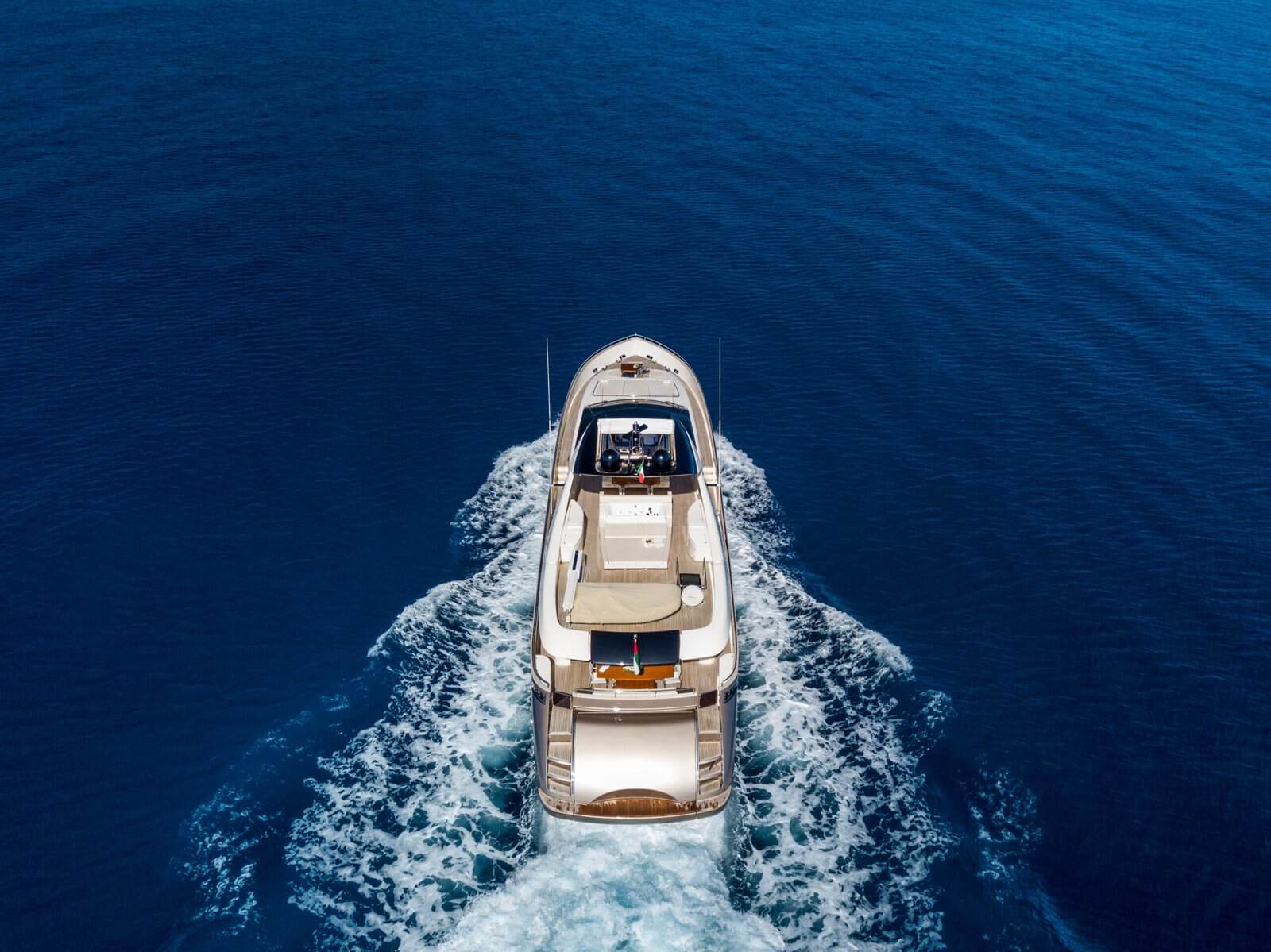 Aerial shot of a yacht sailing on an empty sea