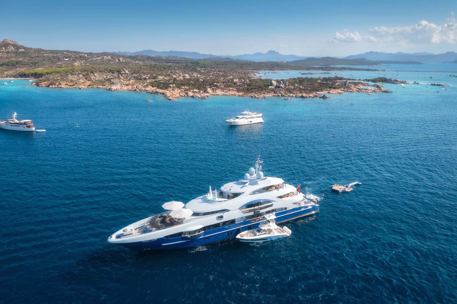 Aerial view of modern yacht sailing through mediterranean sea