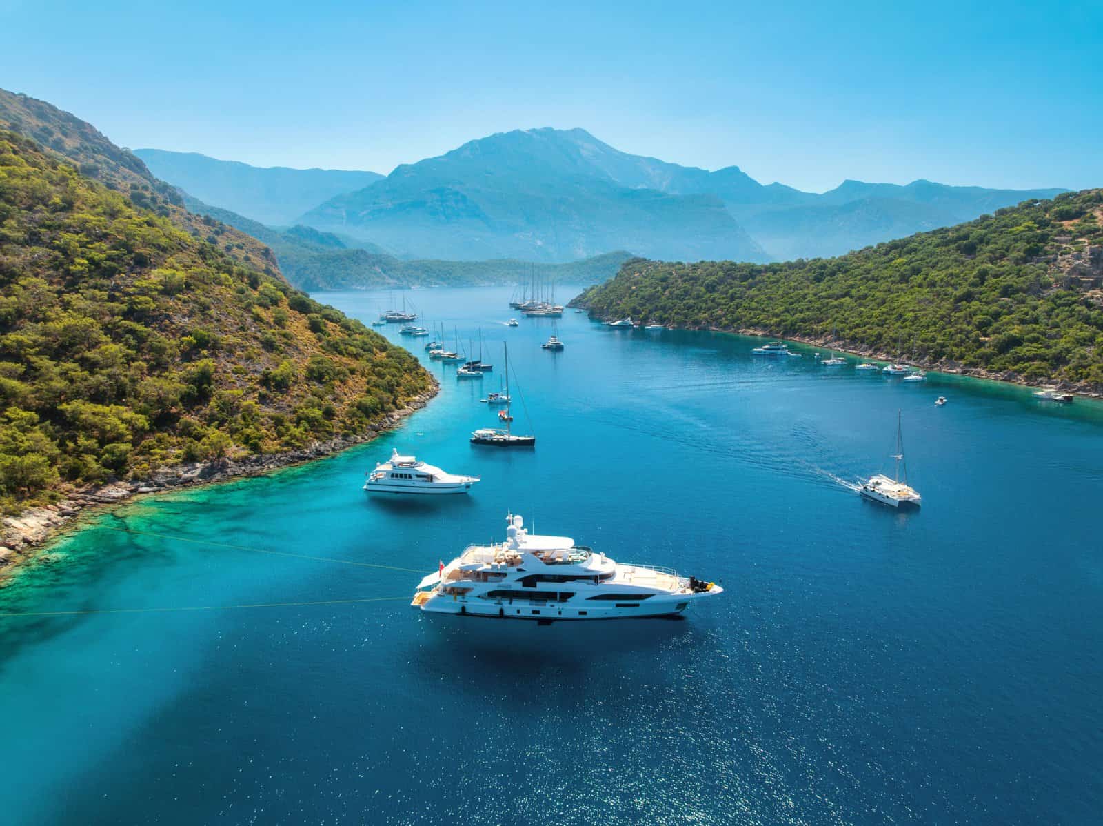 Aerial view of yachts and boats on the sea at sunset in summer