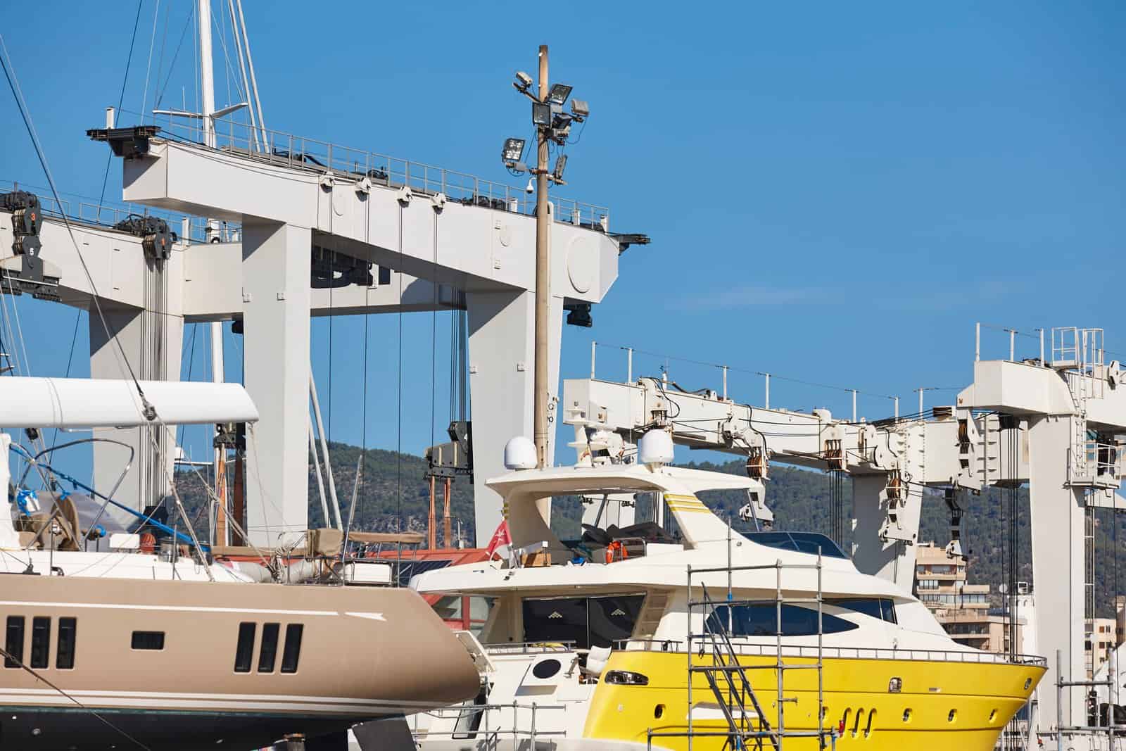 Yacht on an open air shipyard. Nautical maintenance industry. Re