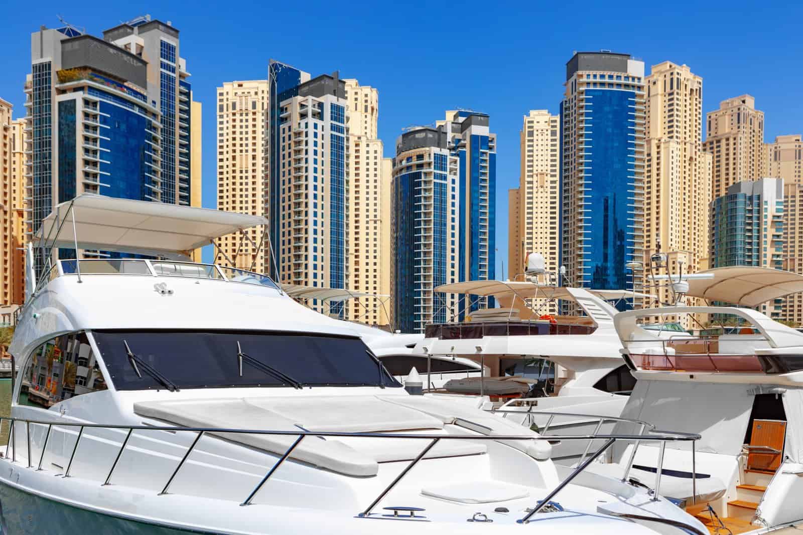 Sea yacht boat against Dubai Marina skyscrapers