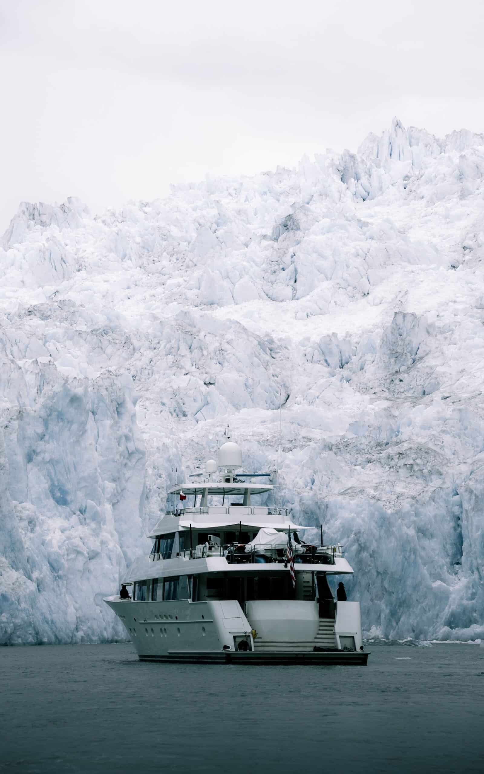 Small boat next to glacier in Alaska