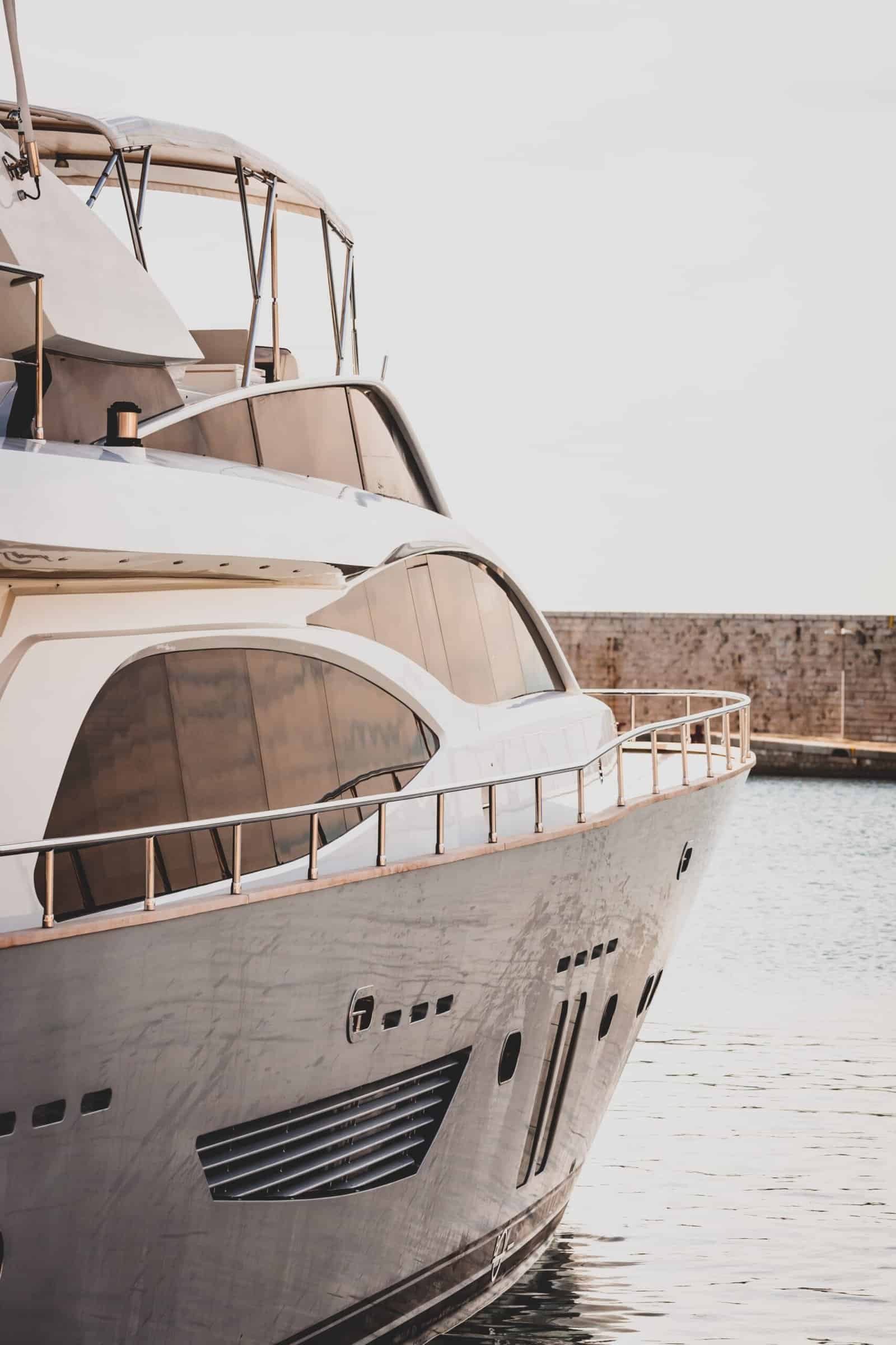 Vertical shot of a white luxury yacht sailing in the sea
