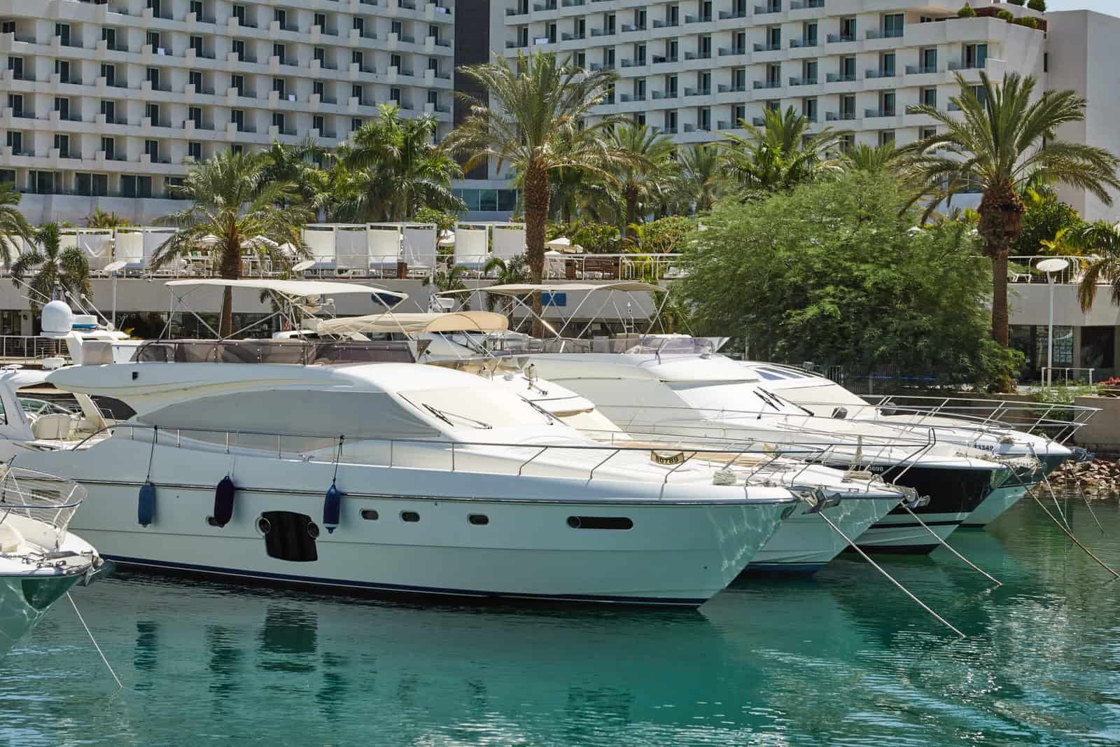 View of the Gulf of Eilat with luxury yachts. On the yacht you can sunbathe, jump into the open sea and enjoy drinks and fruits.