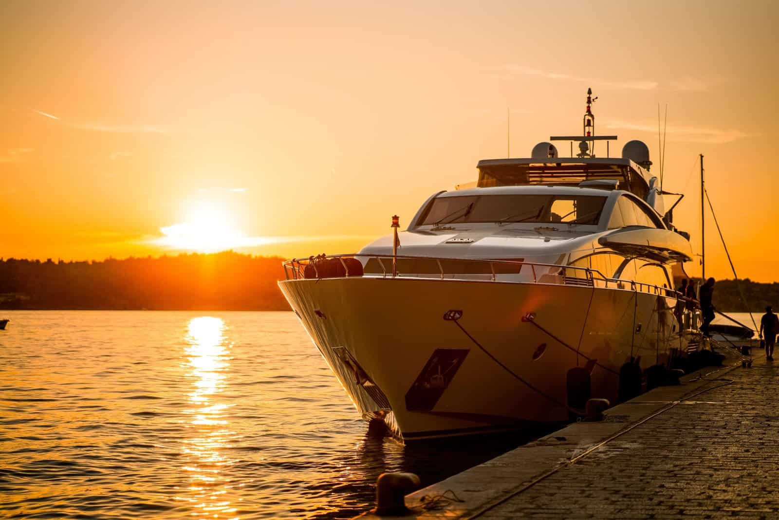 View of yacht standing in Sibenik harbor of Adriatic sea during the golden sunset, Sibenik, Croatia